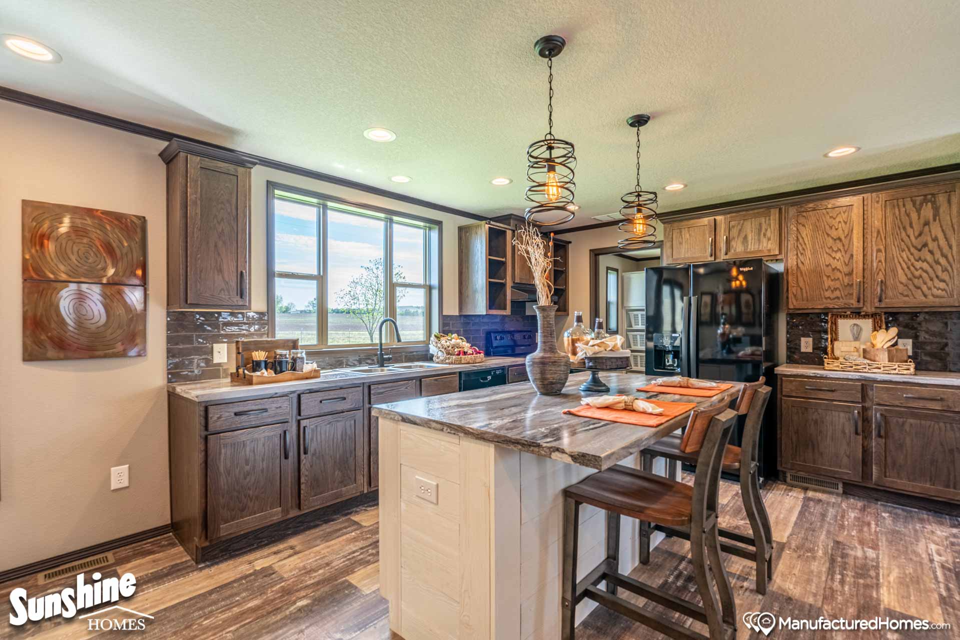 A modern kitchen with dark wood cabinets, marble island, two bar stools, pendant lighting, and large window; warm and inviting atmosphere.