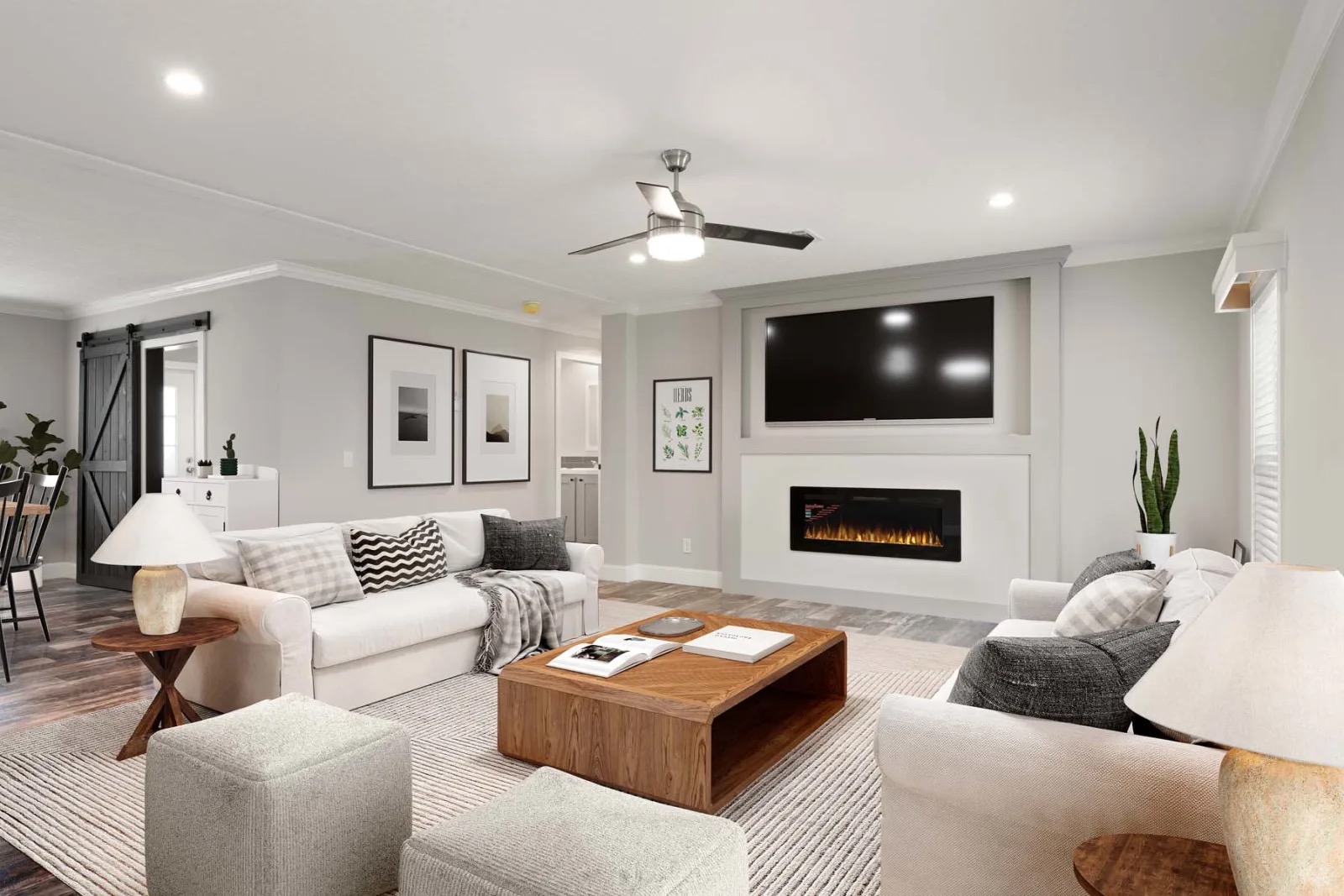 Stylish living room with neutral tones, featuring a white sofa, wooden coffee table, TV above a sleek fireplace, and minimalist decor. Cozy and modern.