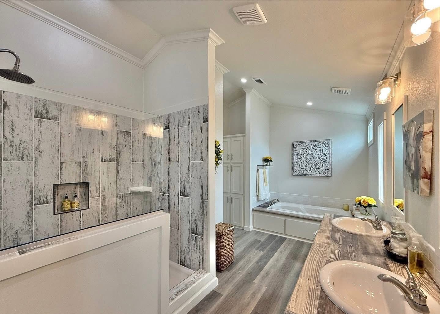 Luxurious bathroom with a rustic, wood-paneled shower, dual sinks, and a large bathtub. Bright, airy space with modern fixtures and soft, neutral tones.