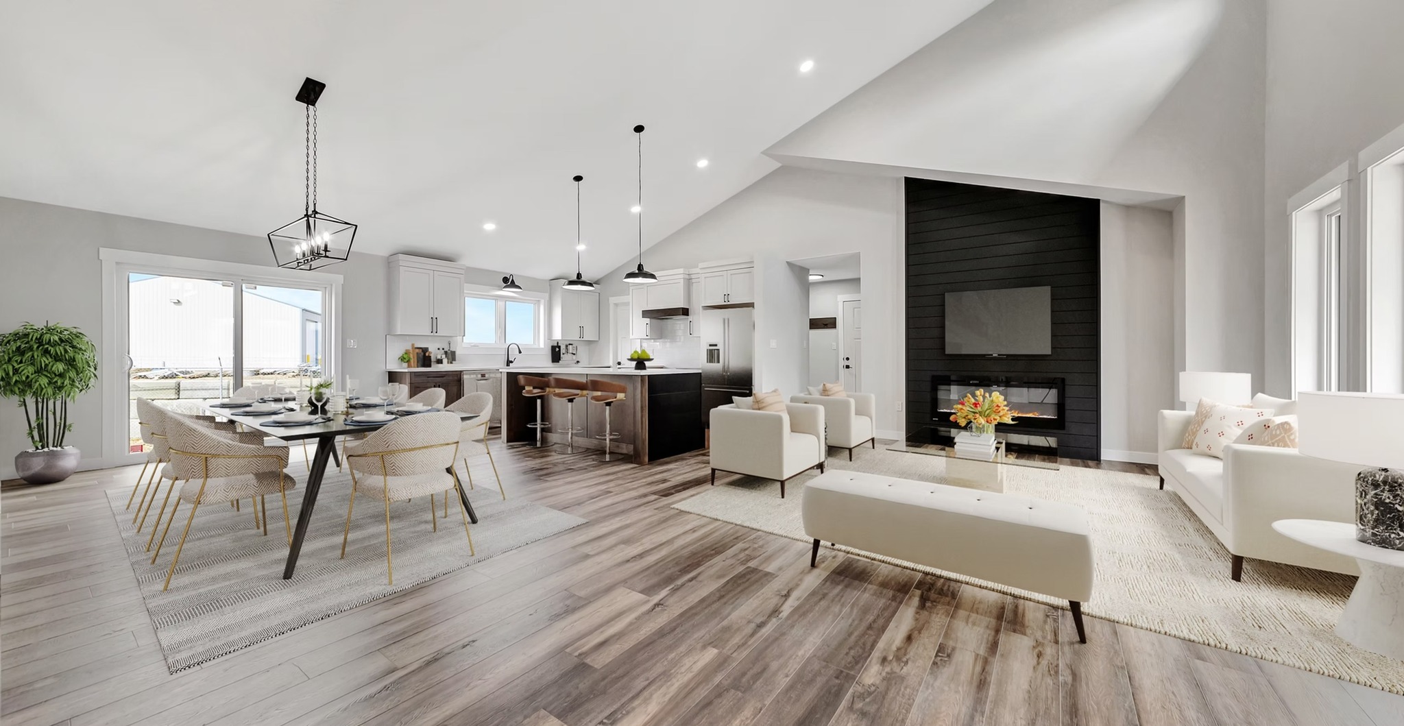 Spacious open-concept living room and kitchen with light wood flooring. Features modern furniture, a black accent wall with a TV, and large windows.