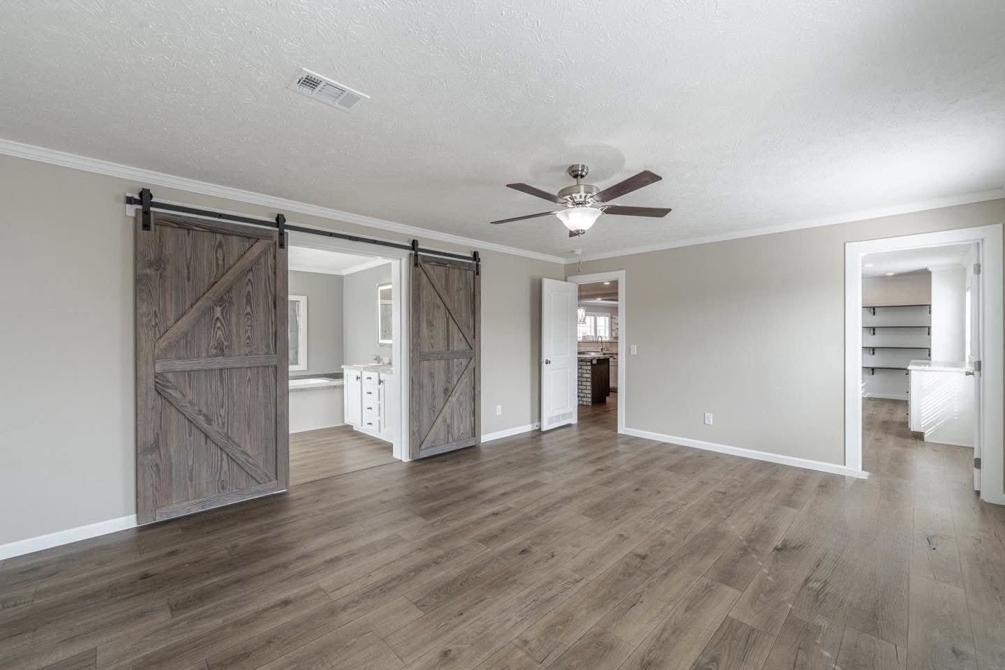 Modern kitchen with a rustic touch, featuring a brick island and wood countertops. Stainless steel appliances, pendant lights, and neutral tones create a cozy atmosphere.