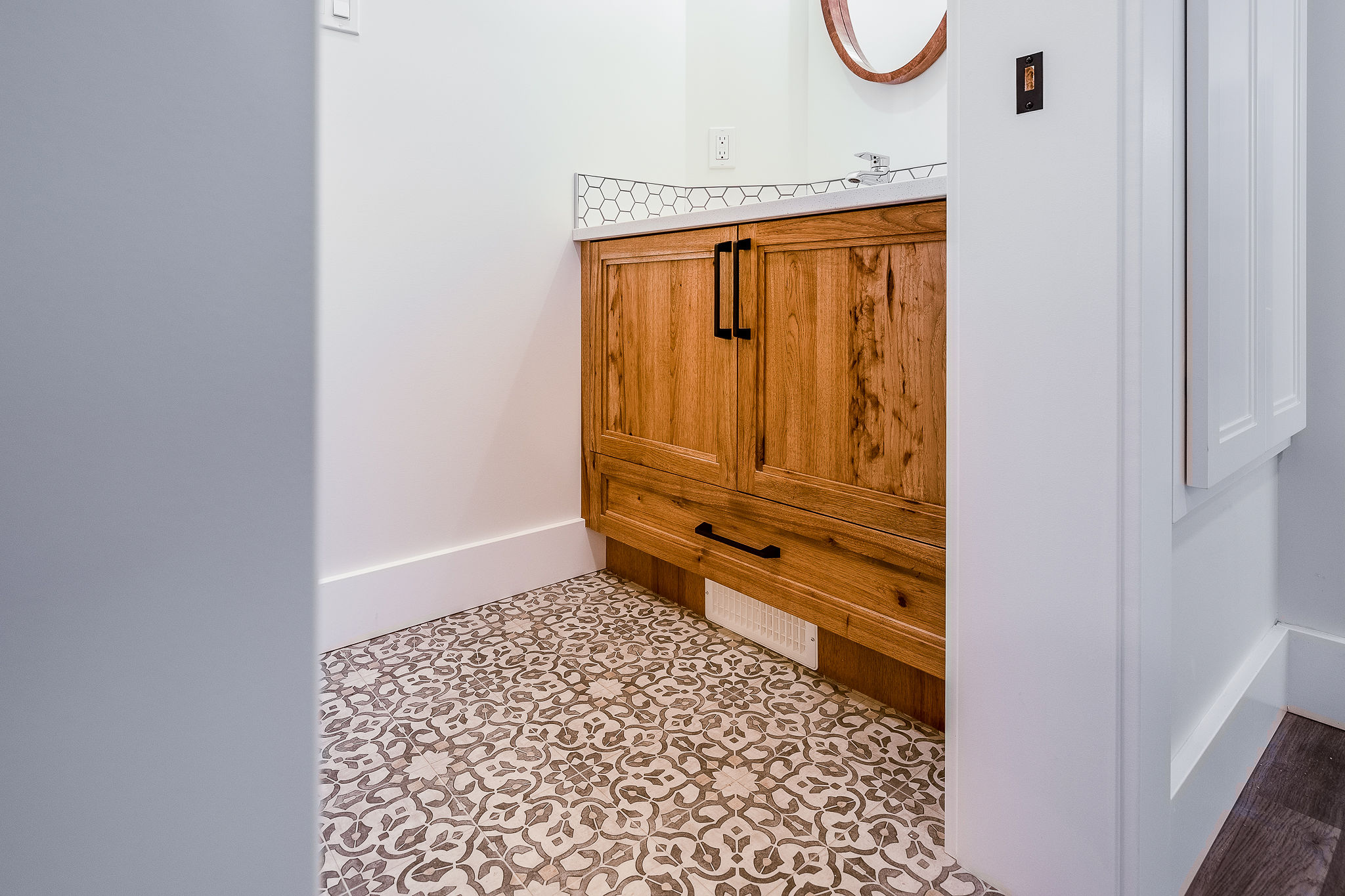 1. A bathroom featuring a wooden cabinet and a tiled floor, creating a warm and inviting atmosphere.