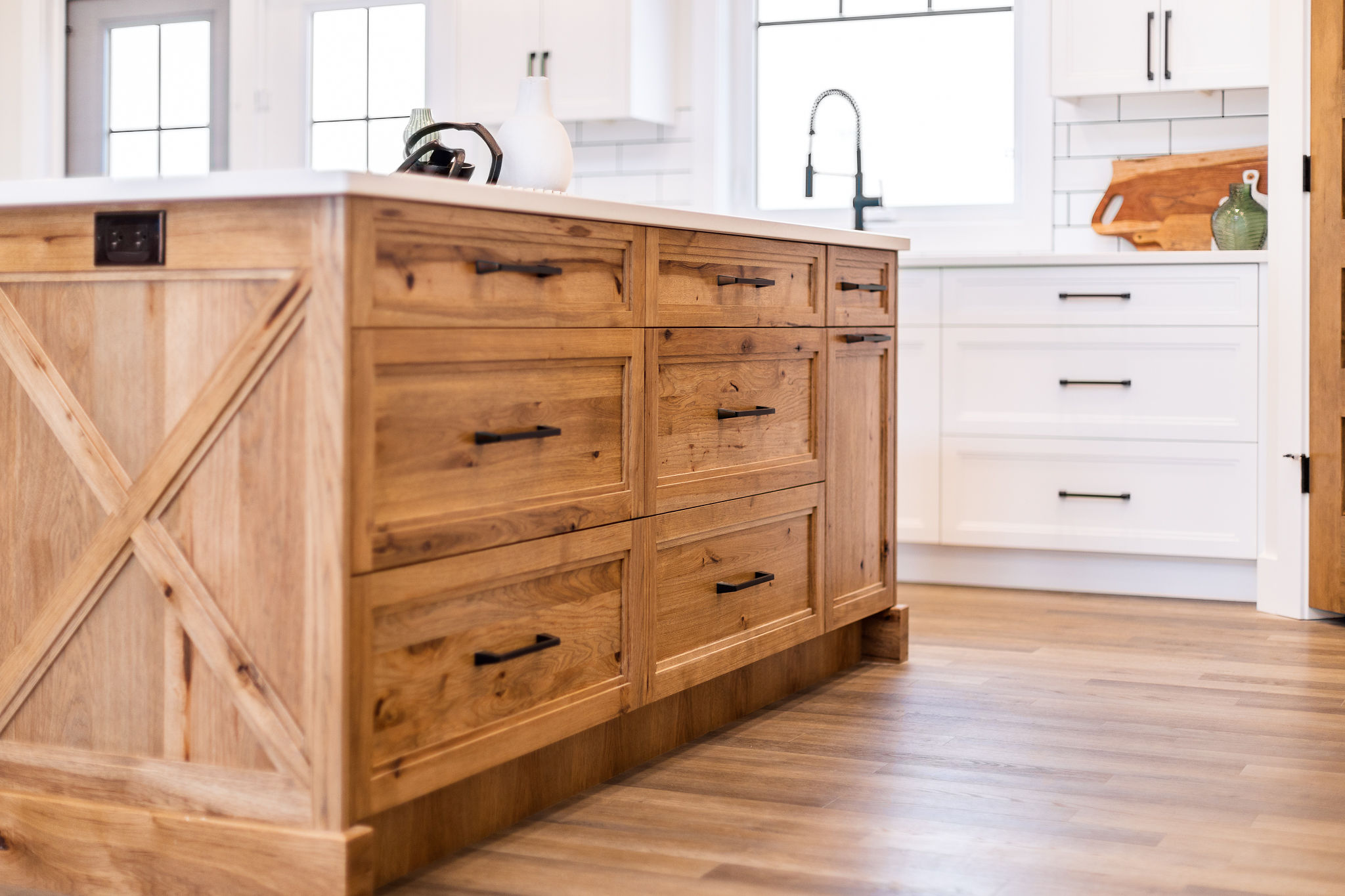 1. A modern kitchen island featuring multiple drawers and cabinets for storage and organization.