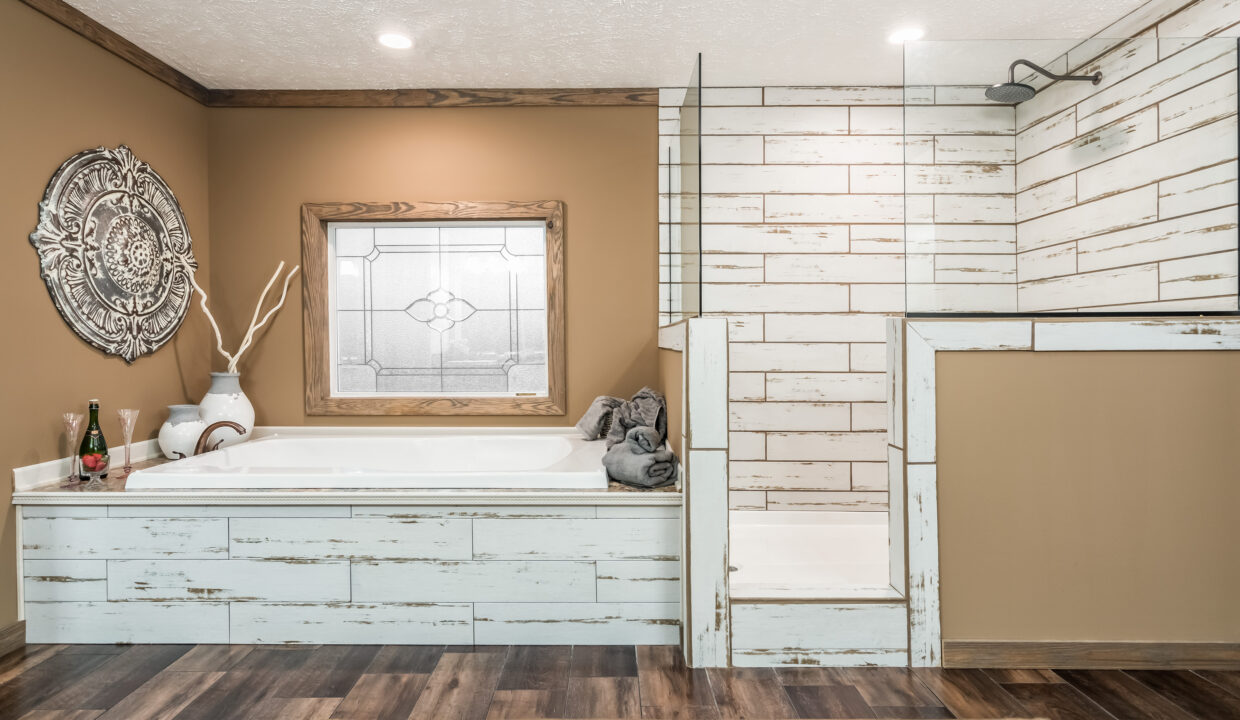 Rustic bathroom with a white shiplap bathtub and shower, brown walls, wood floors, and decorative elements. Soft lighting creates a cozy feel.