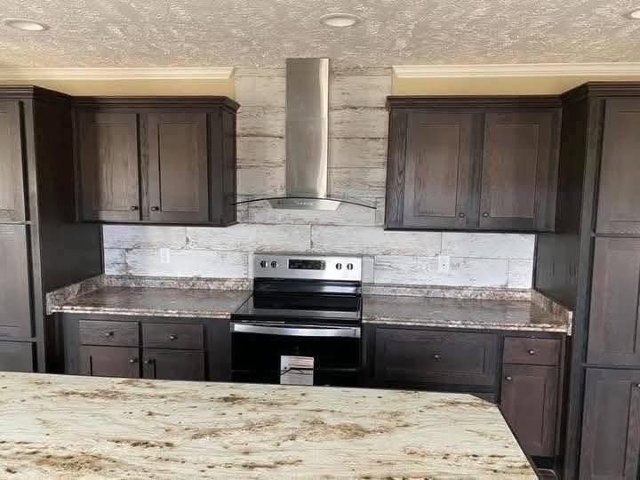 Modern kitchen with dark wood cabinets, granite countertops, and a stainless steel stove under a sleek range hood. Bright, clean, and contemporary.