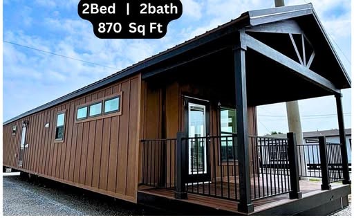 Compact modern tiny house exterior and interior: brown siding, black accents, porch; inside features open living space with couch, table, and kitchenette.
