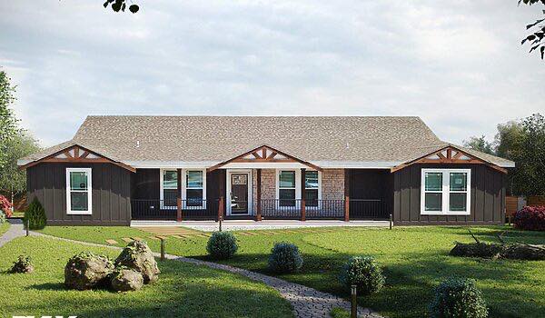 Single-story house with a gabled roof, dark siding, and stone accents. Front porch has white railings. Neat lawn with shrubs and stone path; serene ambiance.