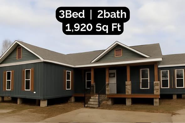 Modern blue-gray house with a gabled roof and wooden accents. Text overlay reads: "3 Bed | 2 Bath, 1,920 Sq Ft." Cozy and inviting.